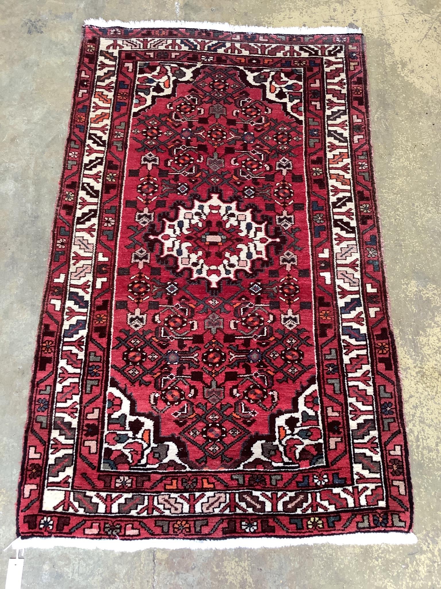 A North West Persian red ground rug, 166 x 100cm